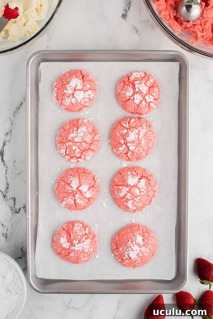 Strawberry cake mix cookies on a sheet pan.