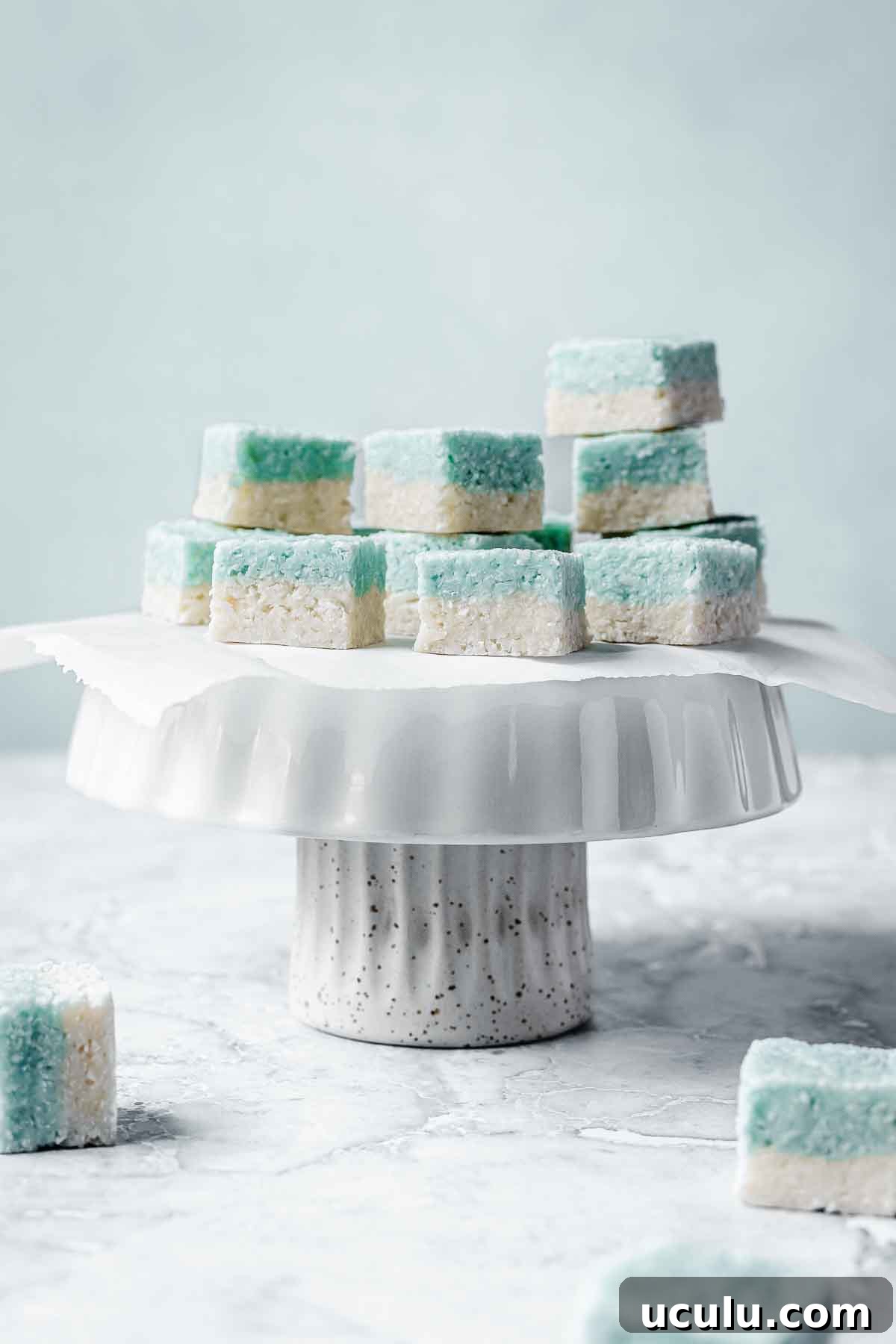 Blue and white candy squares on a white cake stand.
