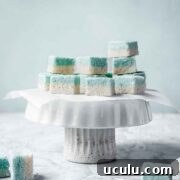 Blue and white candy squares on a white cake stand.