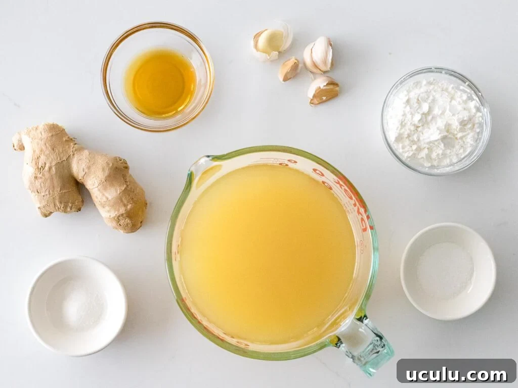 Chinese white sauce ingredients in glass bowls including chicken stock, ginger, and garlic