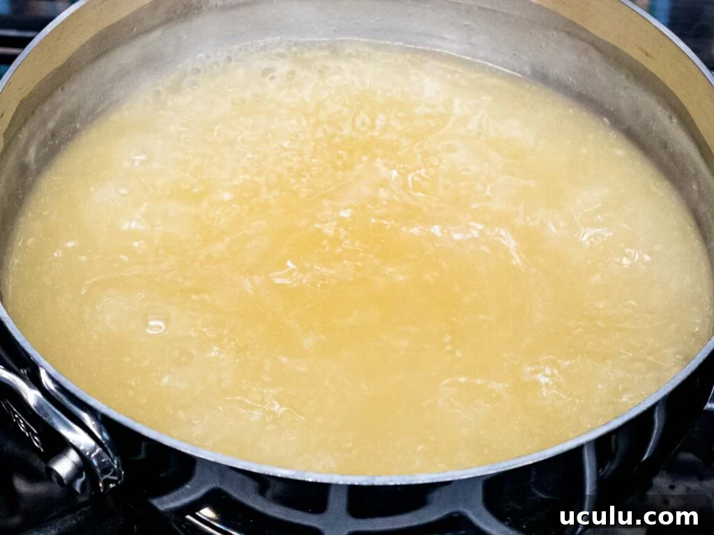 chicken stock boiling in a pot