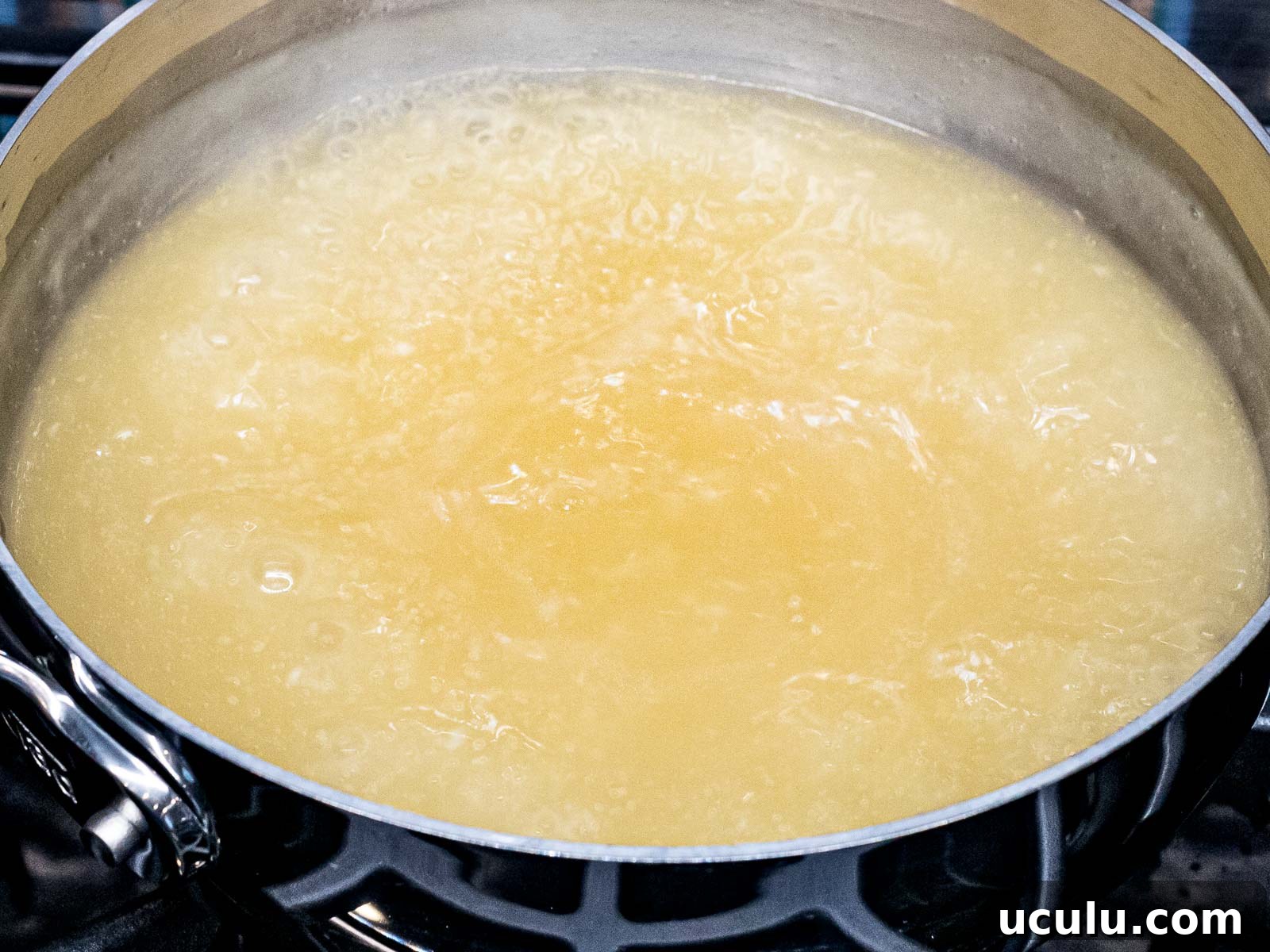 chicken stock boiling in a pot