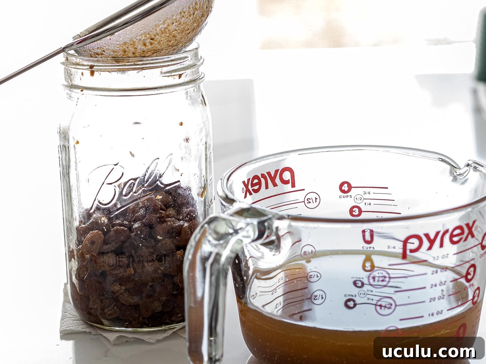 raisin yeast water strained with a mesh strainer and filled in a measuring cup