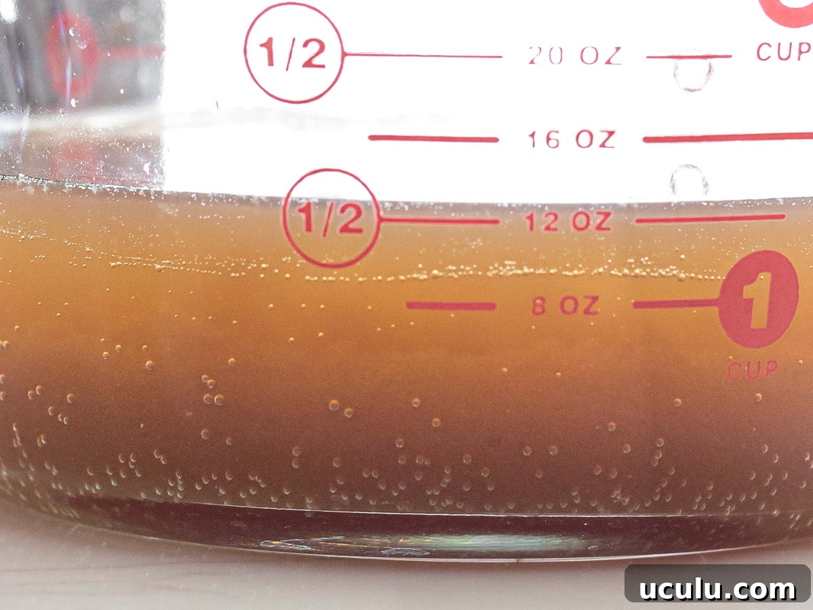 close up of fermented yeast water in a glass measuring cup