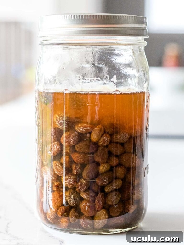 raisin yeast water in a mason glass jar on a white counter top