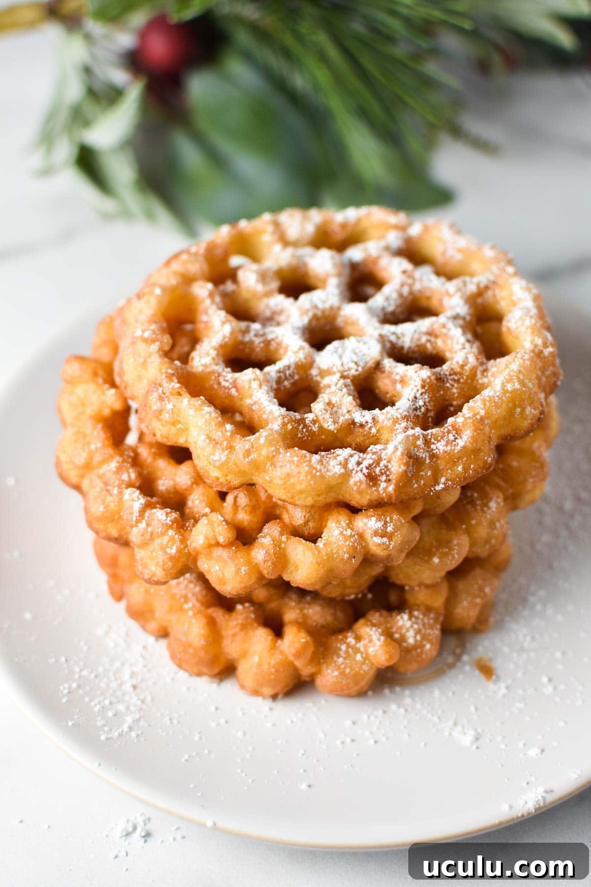 A stack of fried cookies in a snowflake pattern