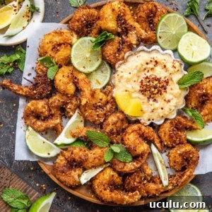 fried Coconut Shrimp on a plate with a sweet dipping sauce in a bowl