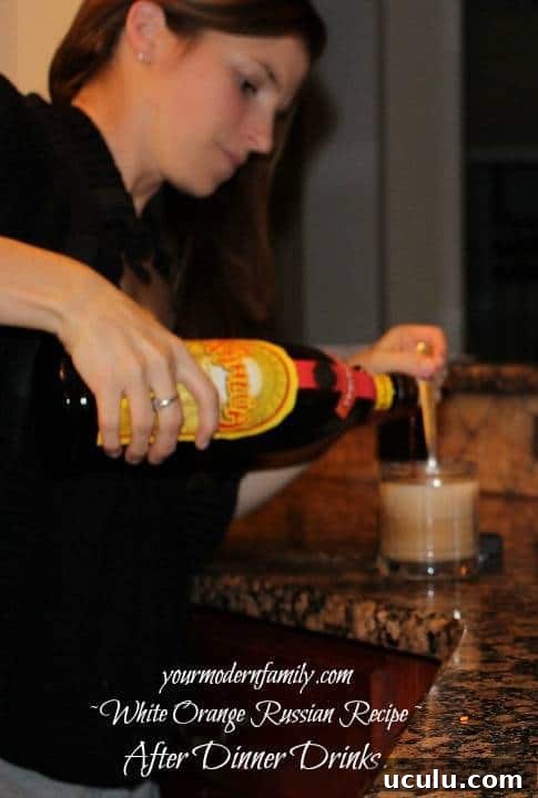 A woman pouring liquor into a glass.
