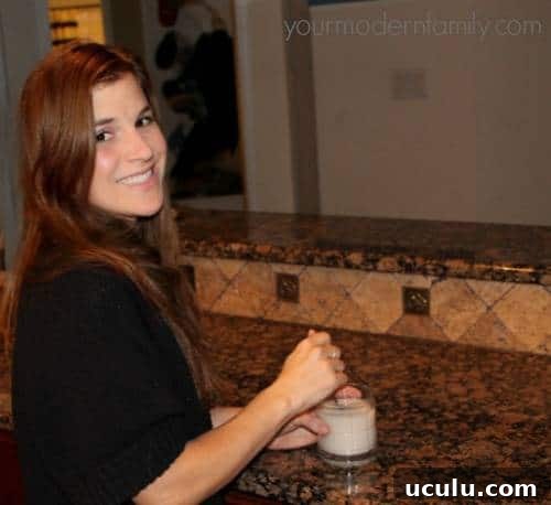 A woman standing near a kitchen counter with a White Russian drink.