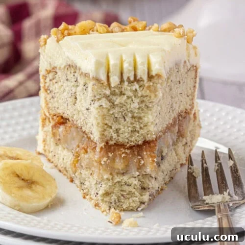 Banana walnut cake slice with a bite removed.