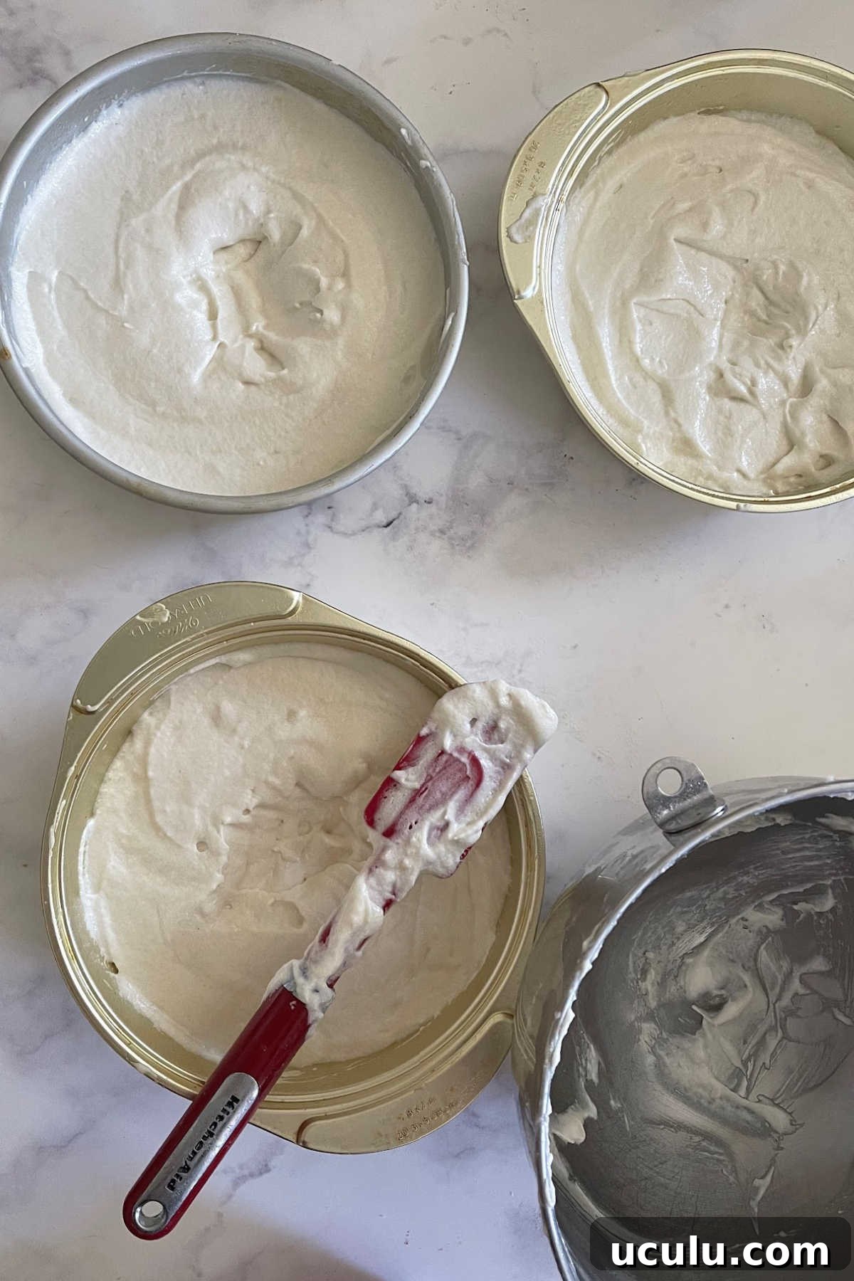 Cake batter is separated into 3 cake pans and ready to bake.