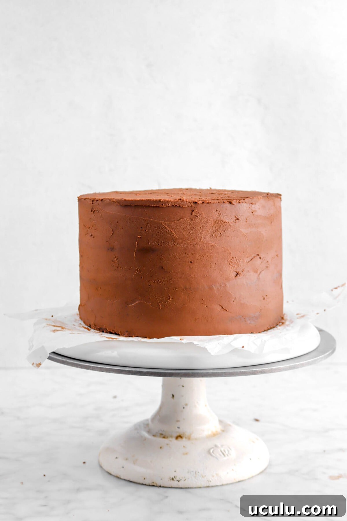 whipped ganache spread around the cake