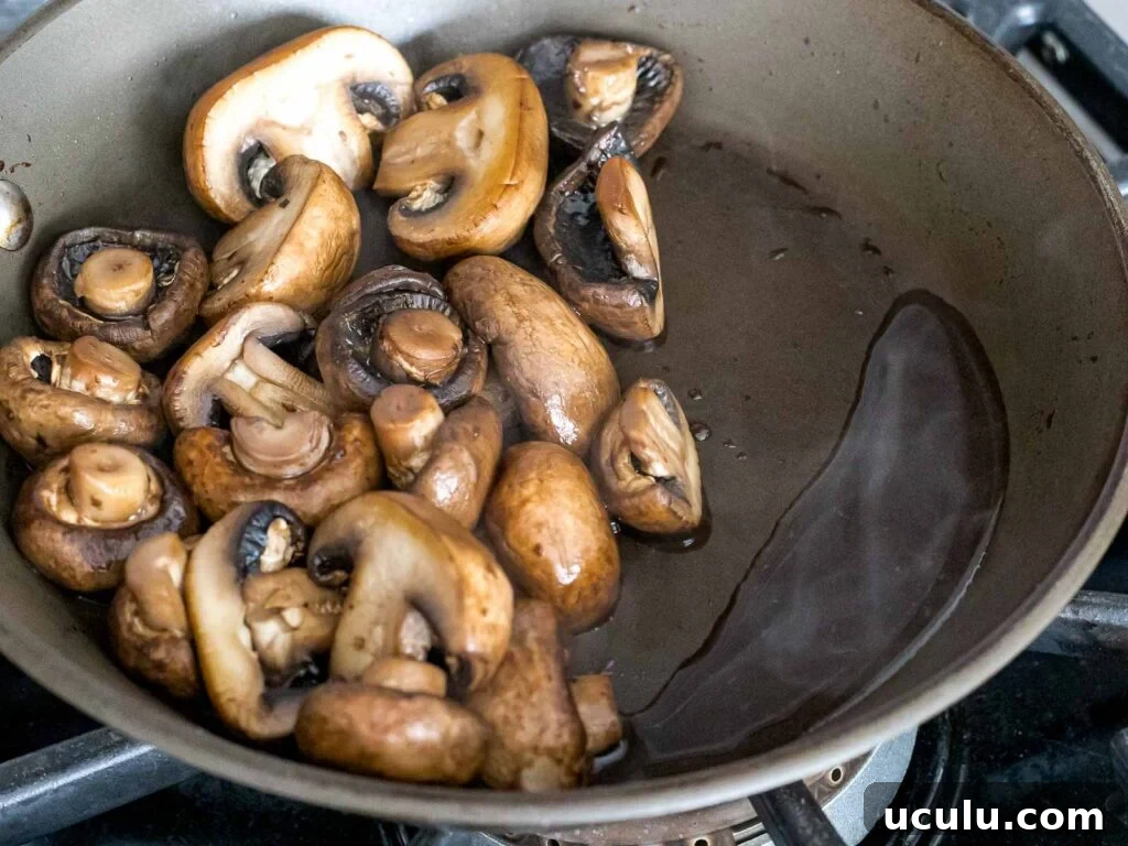 mushrooms releasing liquid after being dry sauteed in a pan