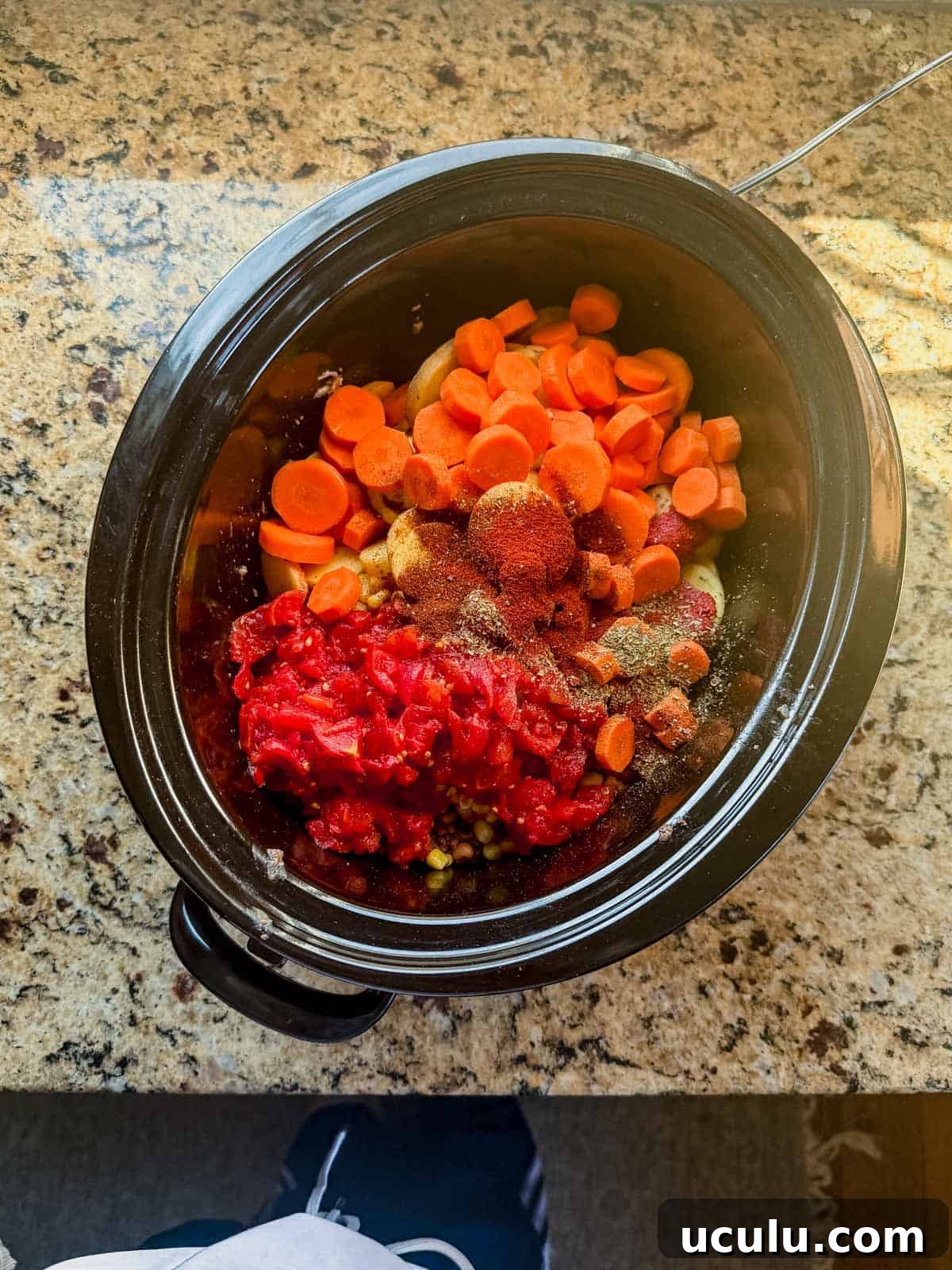 cowboy casserole ingredients in a crock pot.