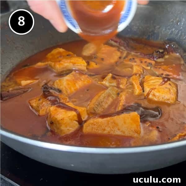 An Indian Salmon curry simmering in a pan