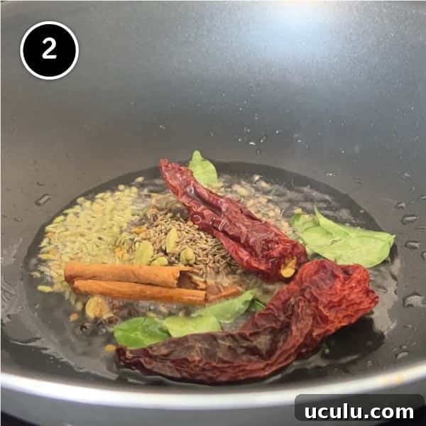 Whole spices and curry leaves simmering in coconut oil