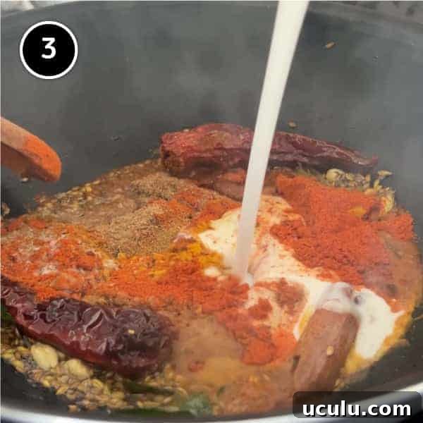 Ground spices and coconut milk forming a curry paste in a pan