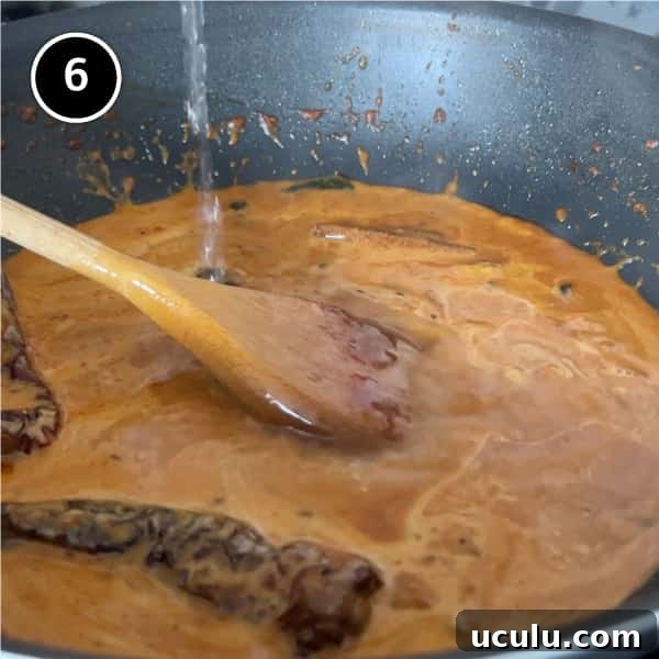 A coconut curry sauce simmers in a pan