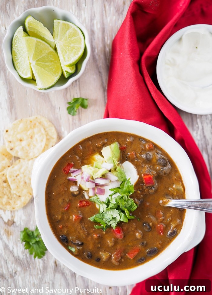 Bowl of black bean soup served with corn chips.