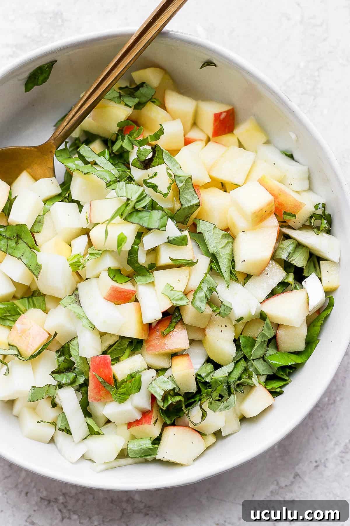 Fennel salad in a bowl, all ingredients mixed together. 