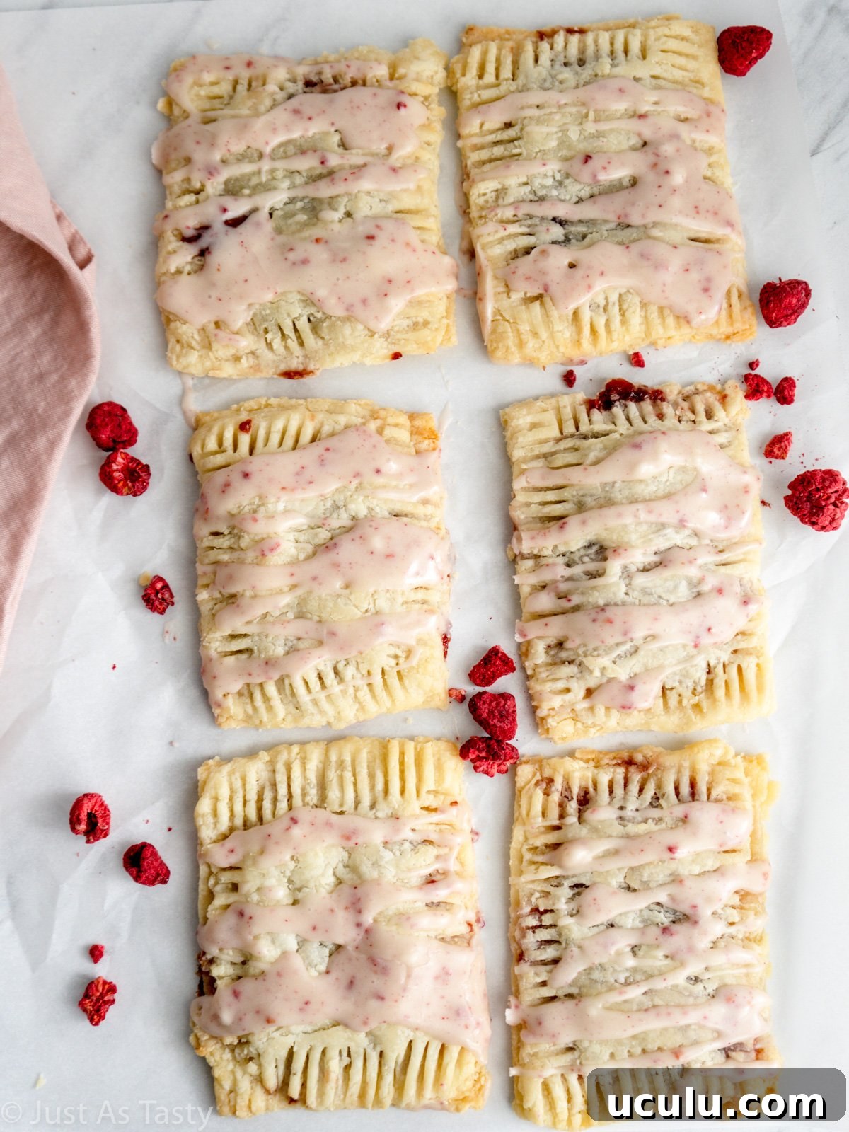 Gluten free pop tarts on white parchment paper.