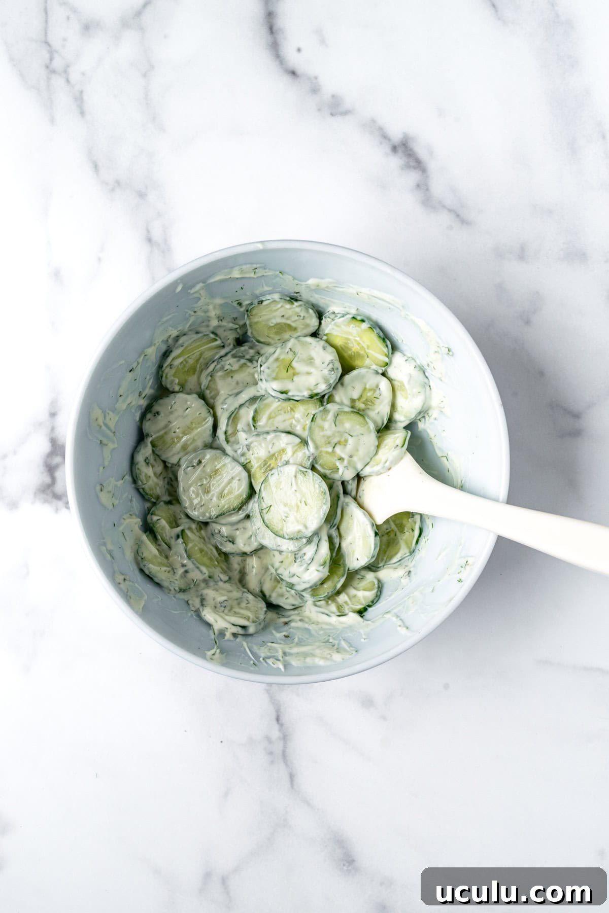 Greek Yogurt Cucumber Salad in a white bowl.