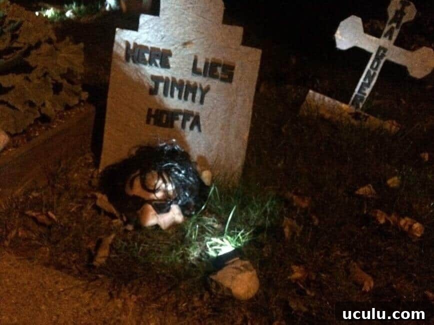 Here Lies Jimmy Hoffa tombstone, with rubber mask on ground.