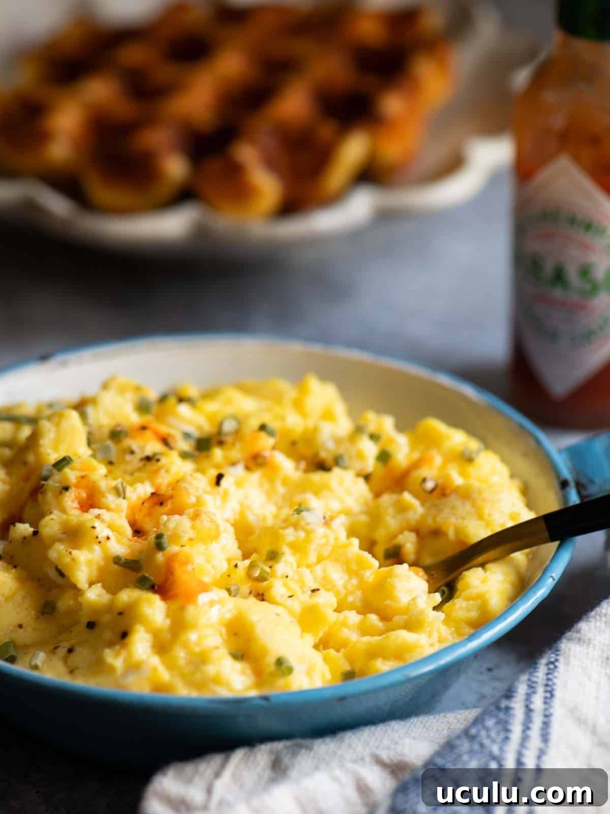 Close up of scrambled eggs with Tobasco sauce on it.