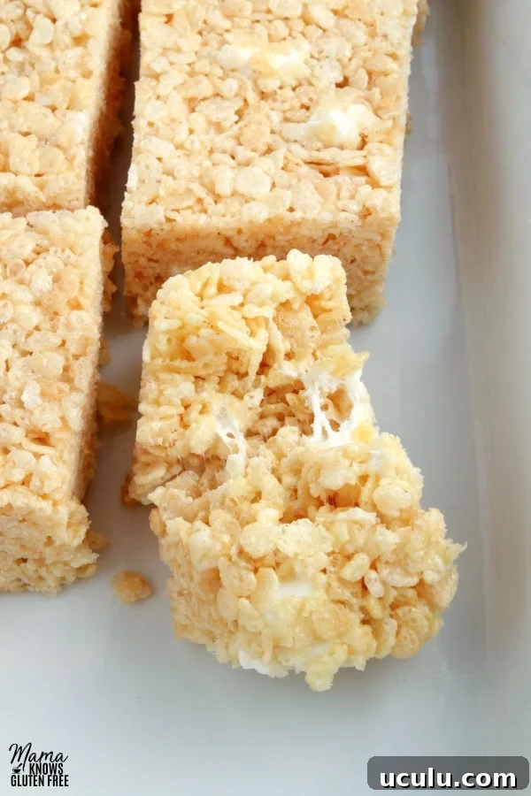 pan of gluten-free rice krispies treats with one broke in half to see the texture