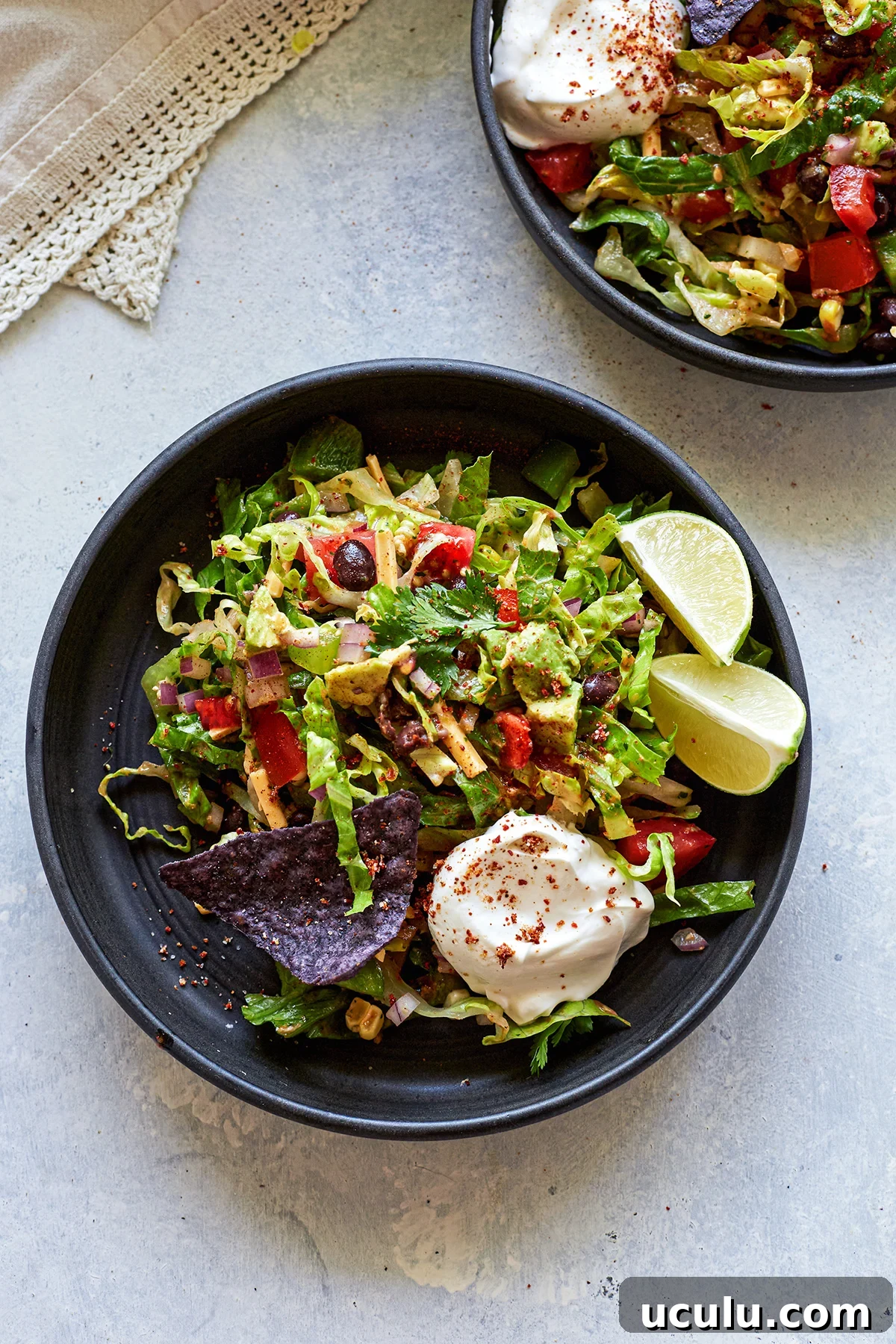 overhead photo of vegetarian taco salad on two black plates