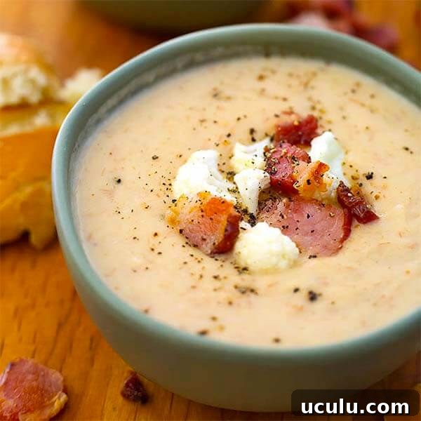 Low-Carb Instant Pot Recipes for Quick Weeknight Meals 15 cauliflower bacon chowder in a green bowl topped with bacon pieces and cauliflower