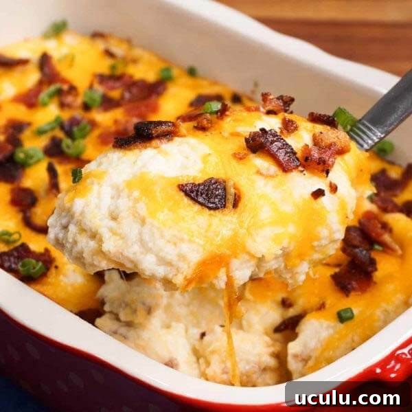 Low-Carb Instant Pot Recipes for Quick Weeknight Meals 18 baked cauliflower casserole in a white and red baking dish with serving spoon scooping out a slice