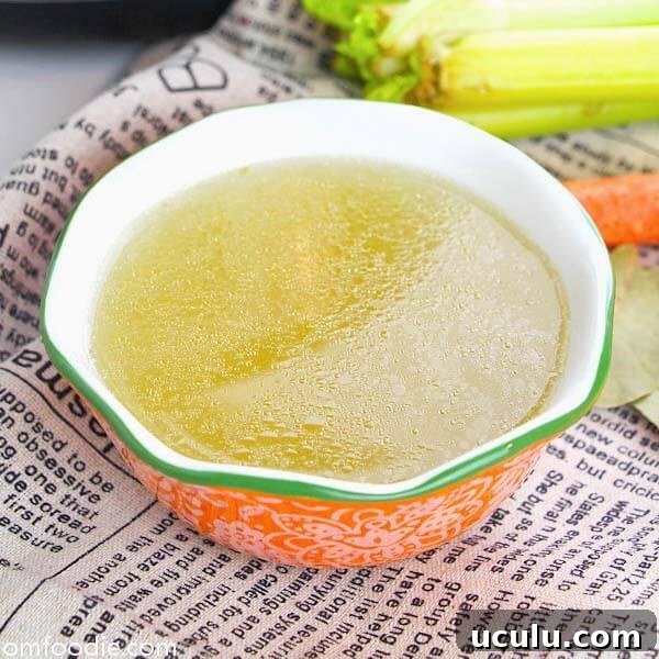 Low-Carb Instant Pot Recipes for Quick Weeknight Meals 10 easy chicken bone broth in orange bowl with green rim on top of news-typed napkin