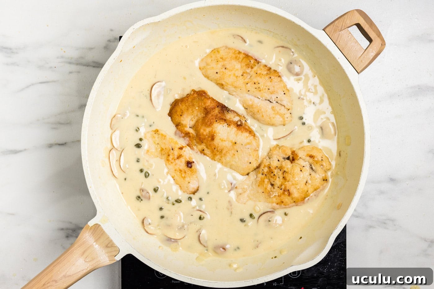 chickn cutlets in Chicken Scallopini sauce in skillet
