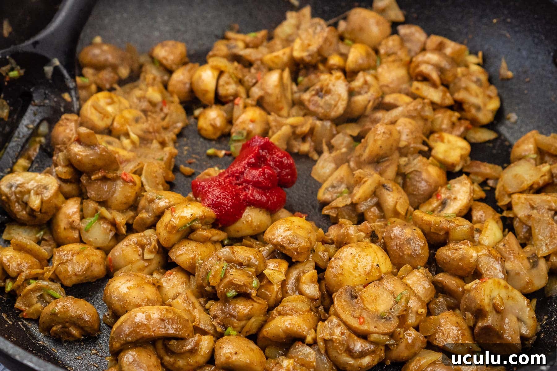 Indian Mushroom Bhaji Recipe | Flavorful Mushroom Curry Guide 21 Tomato puree added to the to the mushroom bhaji cooking in a frying pan