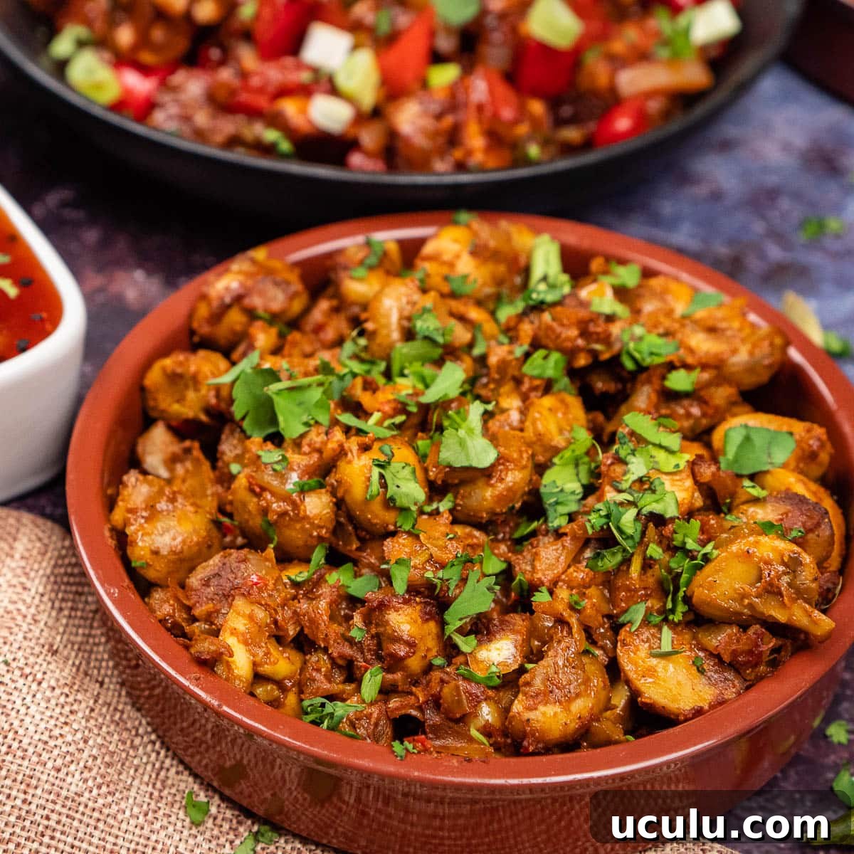 Indian Mushroom Bhaji Recipe | Flavorful Mushroom Curry Guide 24 Mushroom curry in a tapas dish with chopped fresh coriander sprinkled over the top