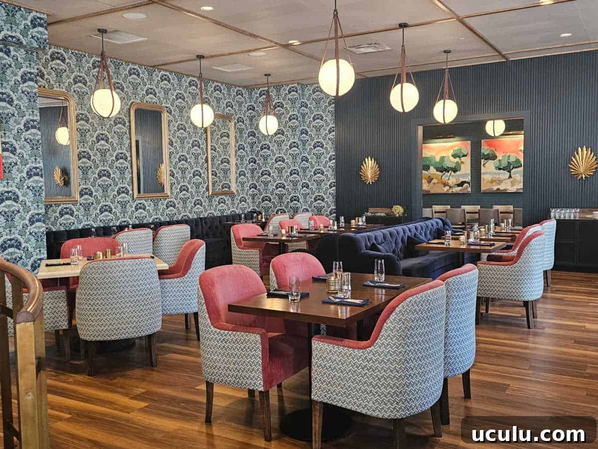 The Bradley Hotel in Fort Wayne, Indiana — Historic Tour Video 9 Arbor restaurant with pink and blue chairs, long blue velvet couch, blue wall paper and hanging ball lights